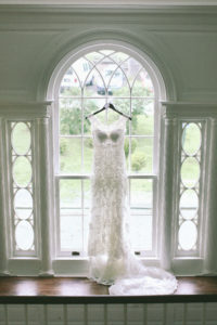 Hannah & Daniel: Manor Wedding, dress hanging in the window