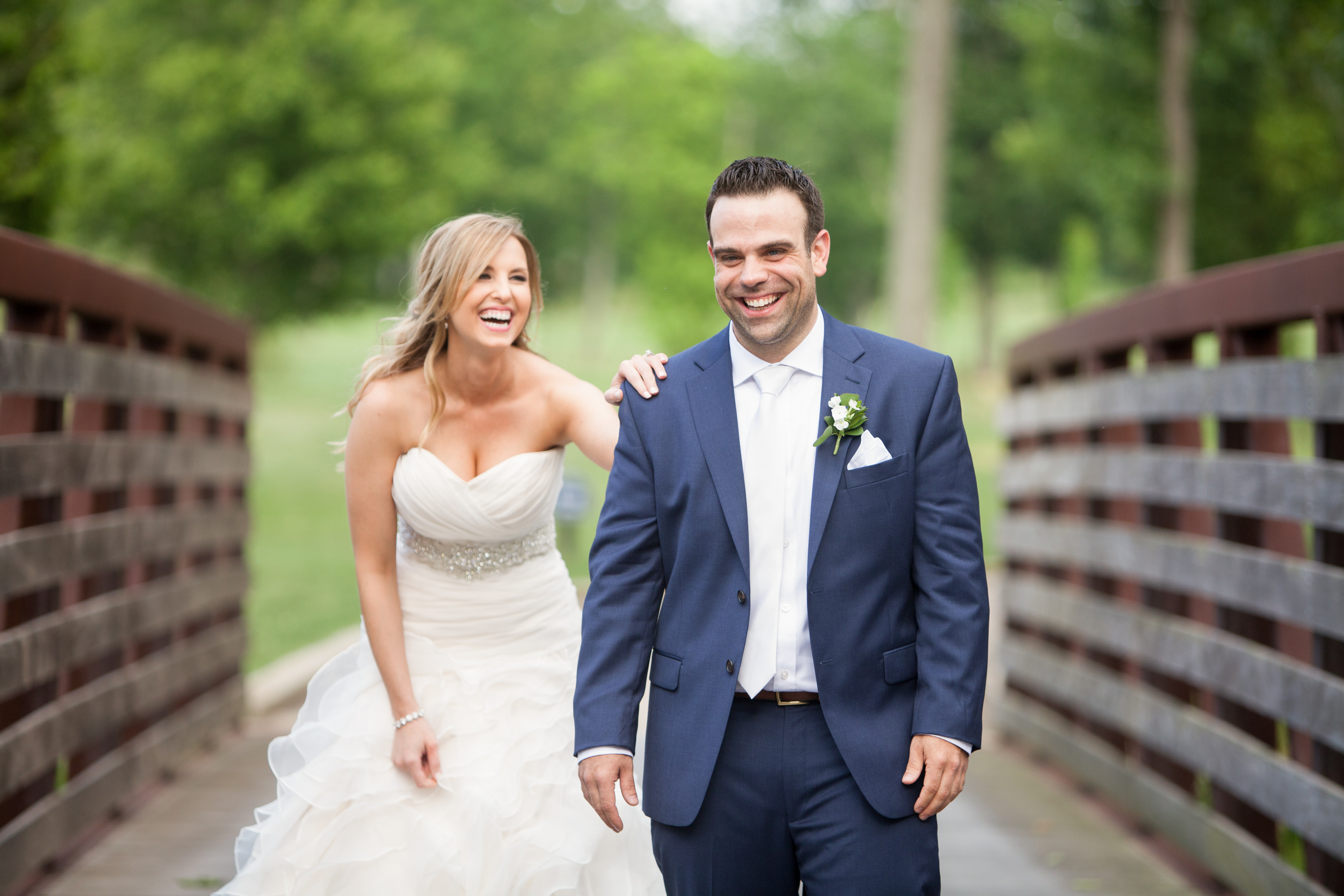 Liz & Jay: Country Club Wedding, groom and bride walking across bridge