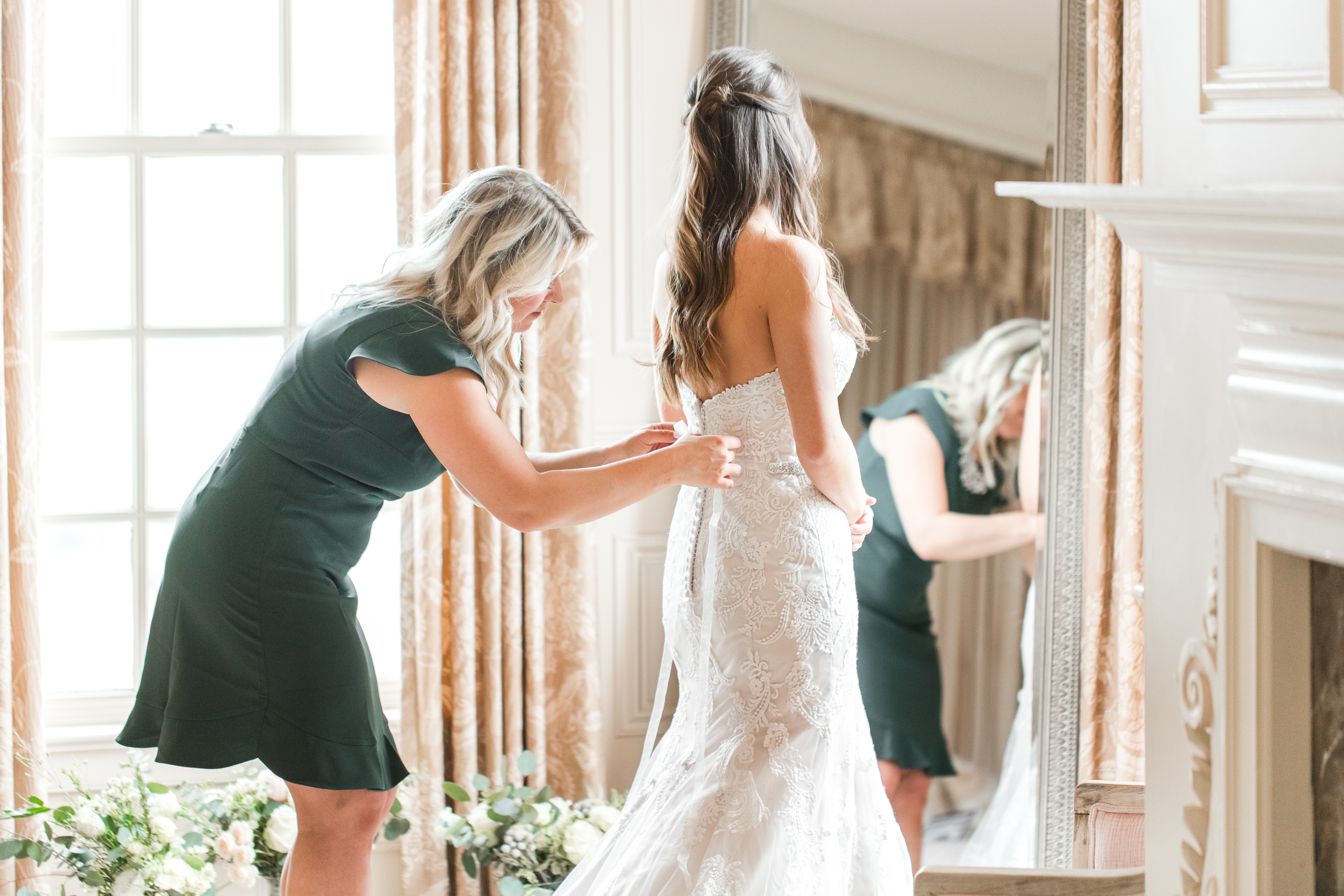 Hiring A Wedding Planner, helping the bride get into her dress