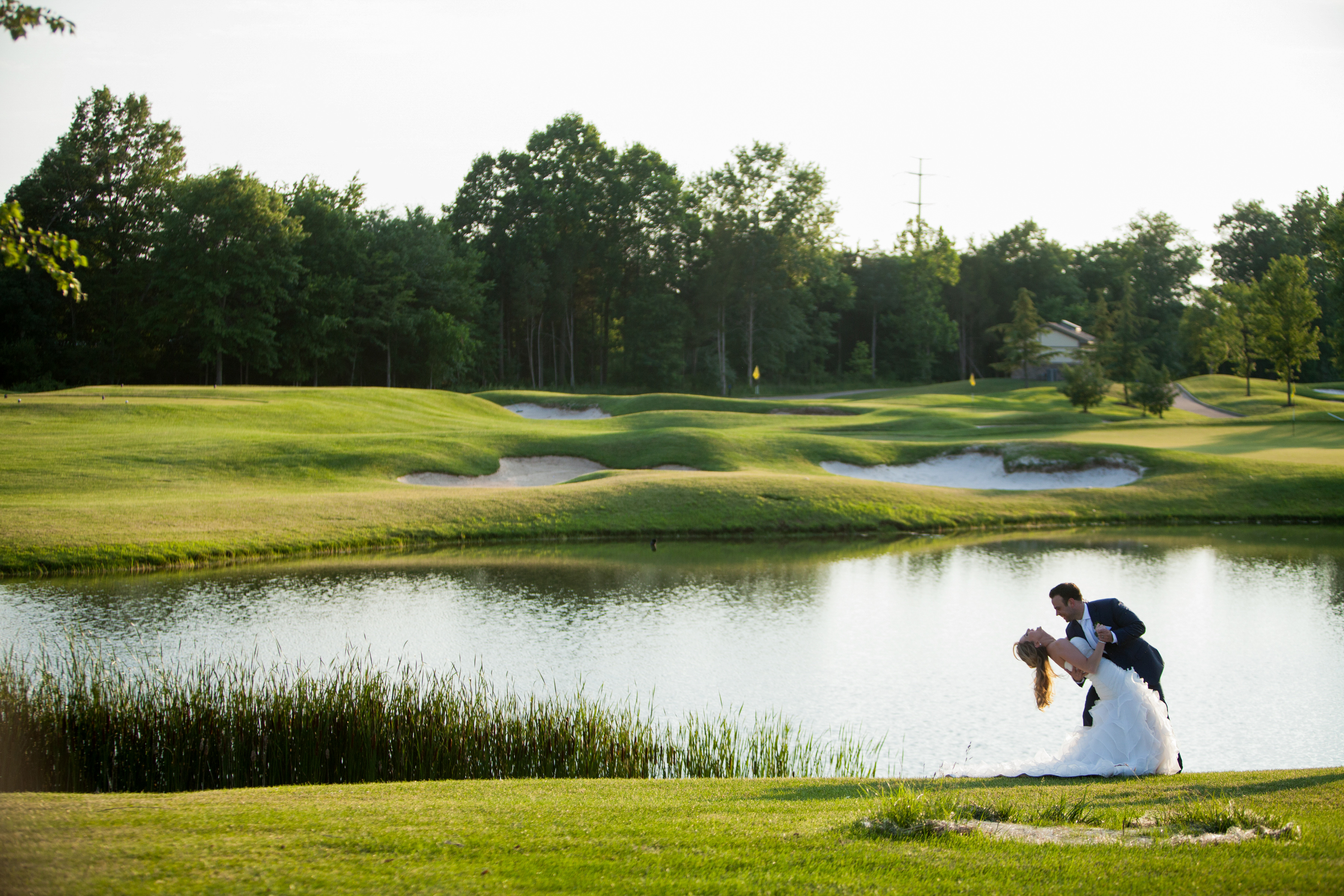 Ways to Cut Venue and Catering Costs, bridal couple standing on golf course